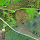 Drone shot of the remains of Sylt, with a memorial in the inset.